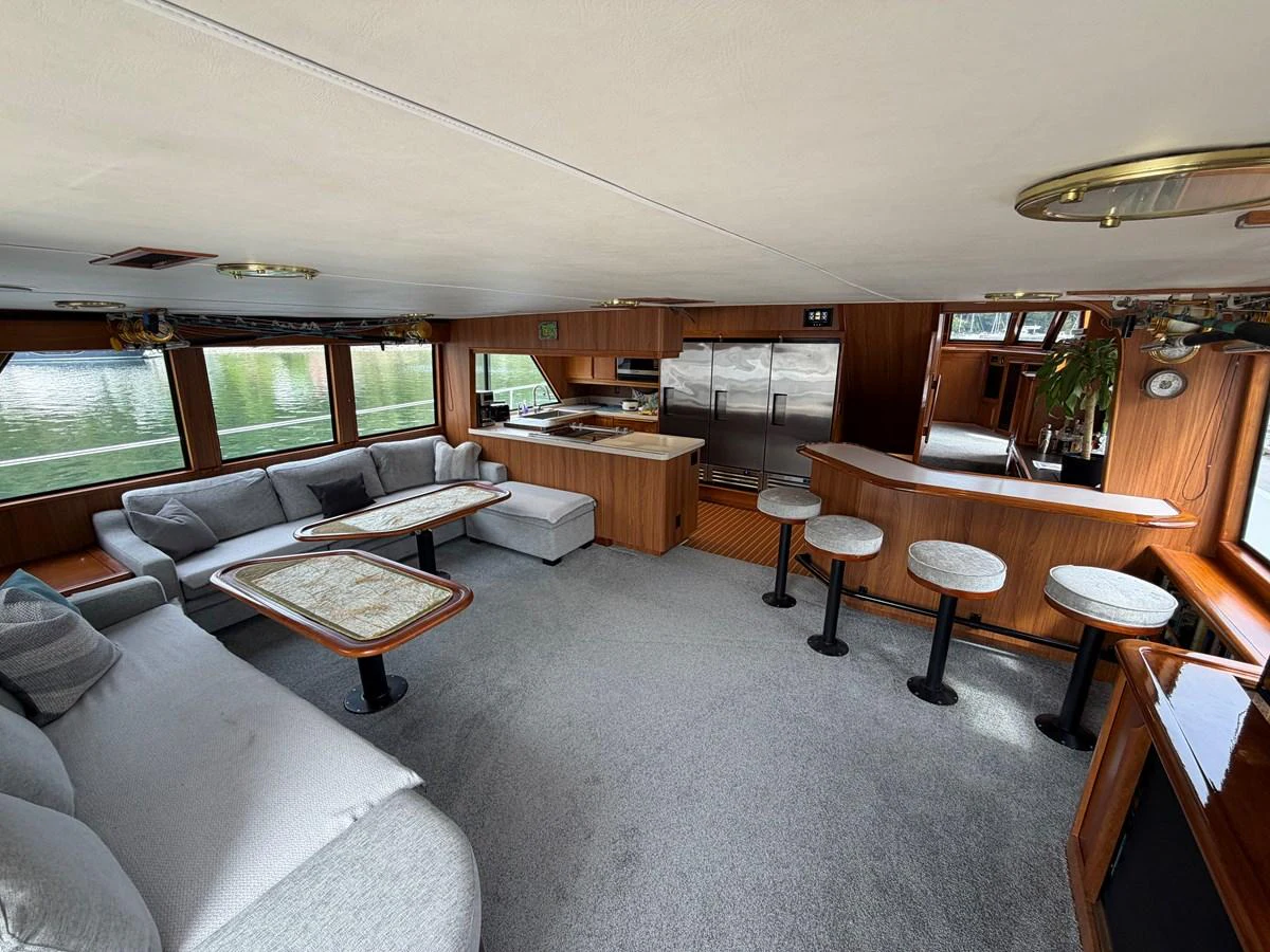 The salon features a spacious seating area with a modern kitchen and bar, offering a comfortable and stylish environment. aboard OCEAN PACIFIC Yacht for Sale