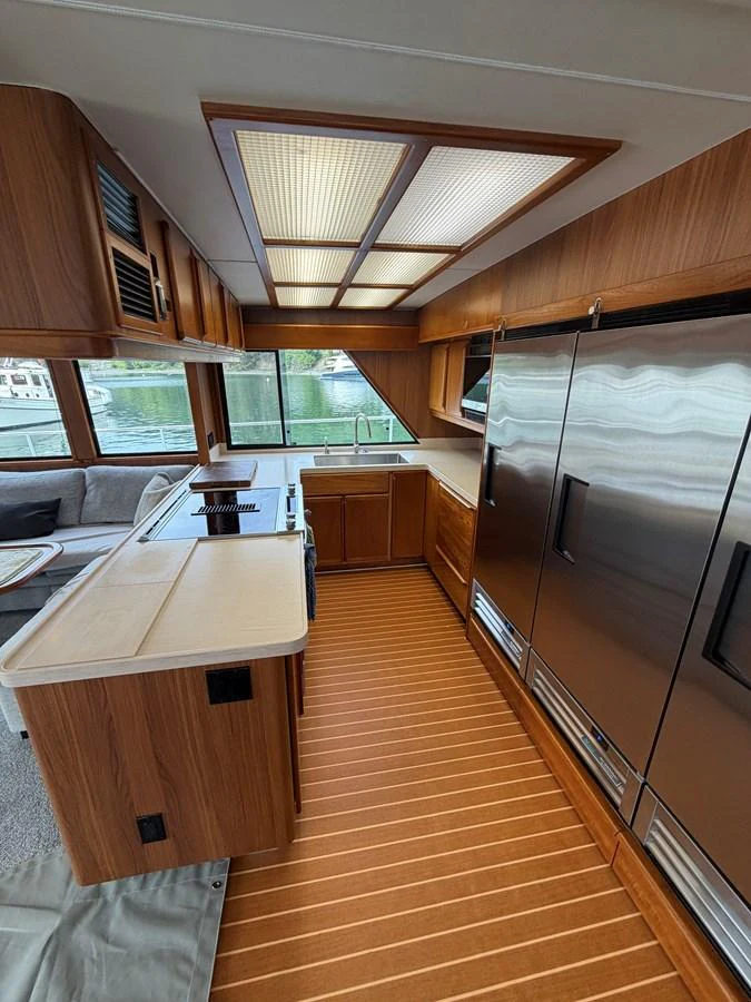 The galley features modern appliances and a sleek design with ample natural light. aboard OCEAN PACIFIC Yacht for Sale