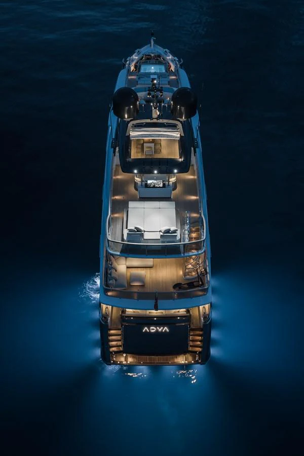 A stunning aerial view of a yacht illuminated at night, showcasing its elegant design and luxurious amenities. aboard ADVA Yacht for Sale