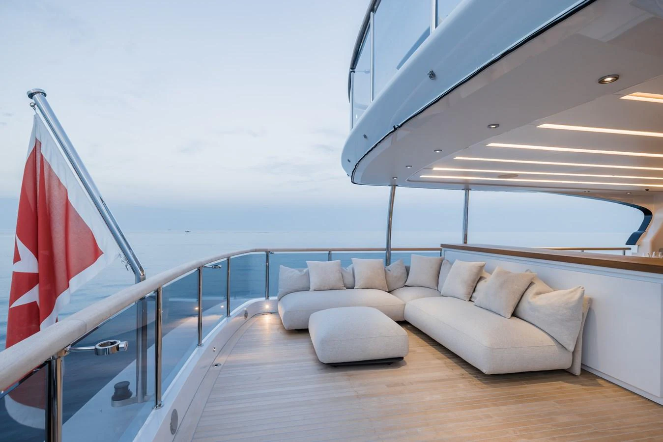 The aft deck features a luxurious lounging area with plush seating and stunning ocean views. aboard ADVA Yacht for Sale