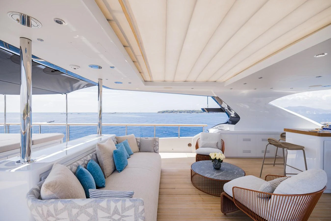 The aft deck features a luxurious seating area with plush cushions and a stunning ocean view. aboard ADVA Yacht for Sale
