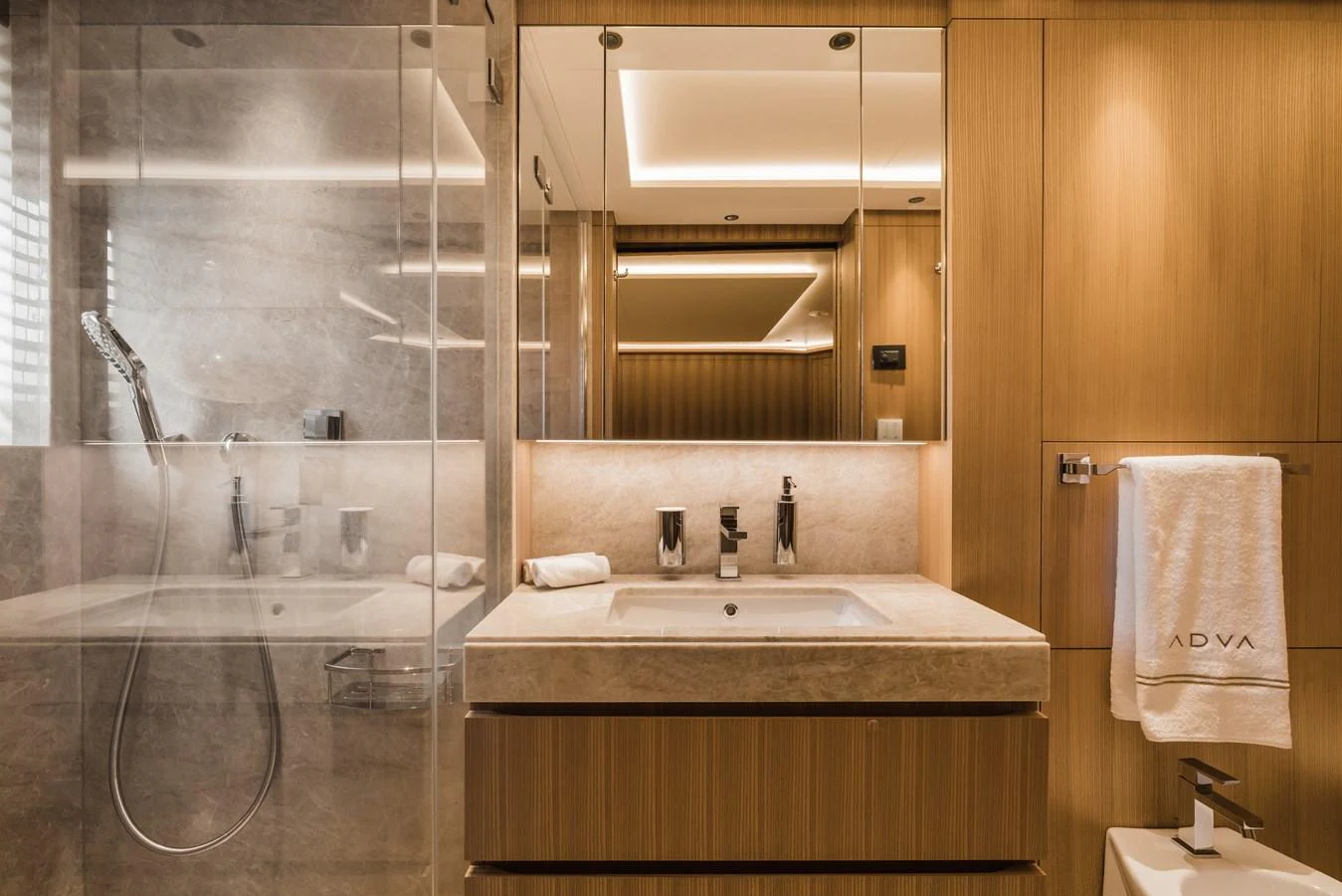 The yacht's bathroom features elegant wood paneling and modern fixtures, creating a luxurious and serene atmosphere. aboard ADVA Yacht for Sale
