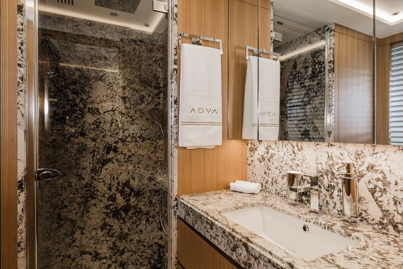 A luxurious bathroom featuring elegant marble surfaces and modern fixtures. aboard ADVA Yacht for Sale