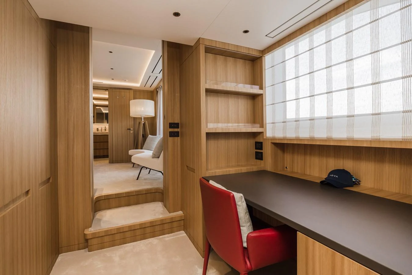 The yacht's interior features a sophisticated office space with wooden accents and modern furnishings. aboard ADVA Yacht for Sale