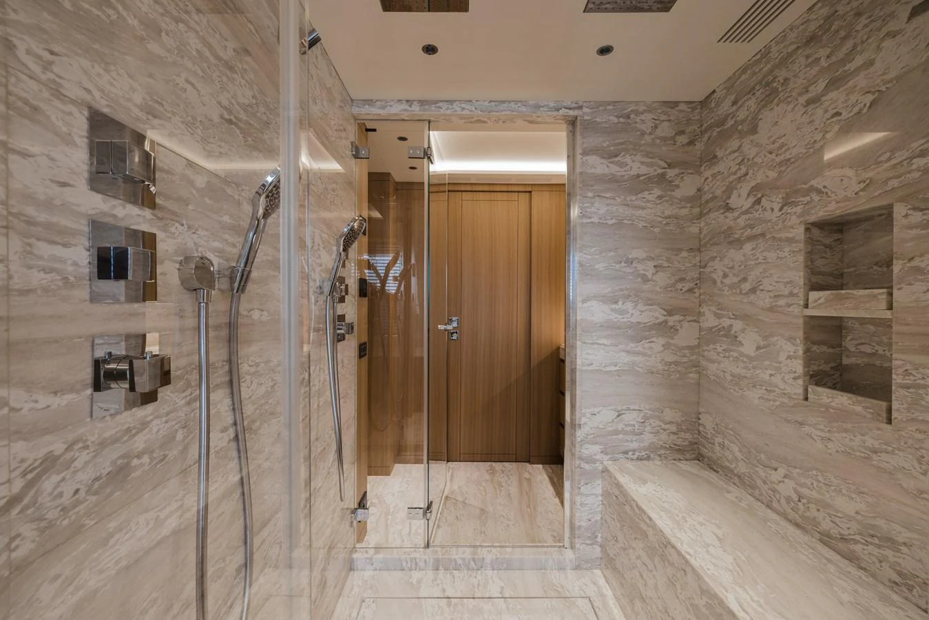 The luxurious bathroom features elegant marble walls and a spacious shower area. aboard ADVA Yacht for Sale