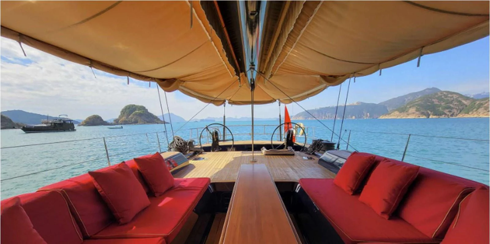 The yacht's aft deck features comfortable seating with stunning views of the surrounding waters and mountains. aboard NAUTOR SWAN 90 Yacht for Sale