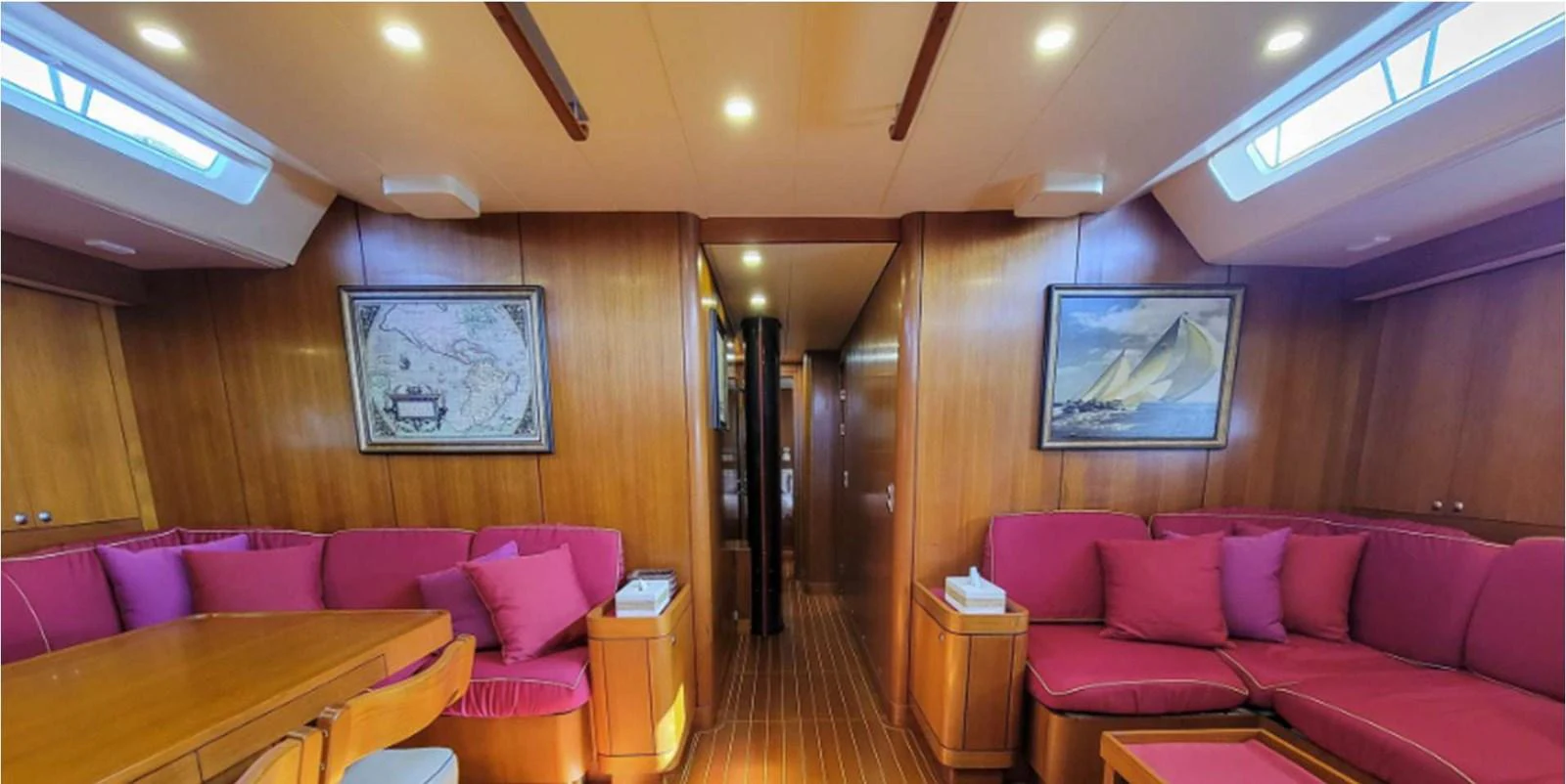 The salon features plush seating and elegant wooden finishes, creating a warm and inviting atmosphere. aboard NAUTOR SWAN 90 Yacht for Sale