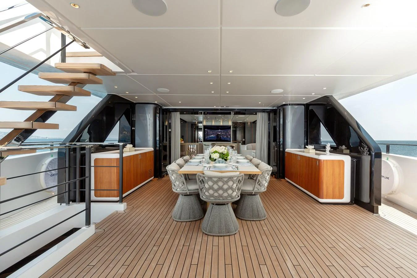 The aft deck features a stylish dining area with elegant seating and modern decor. aboard LADY DIA Yacht for Sale
