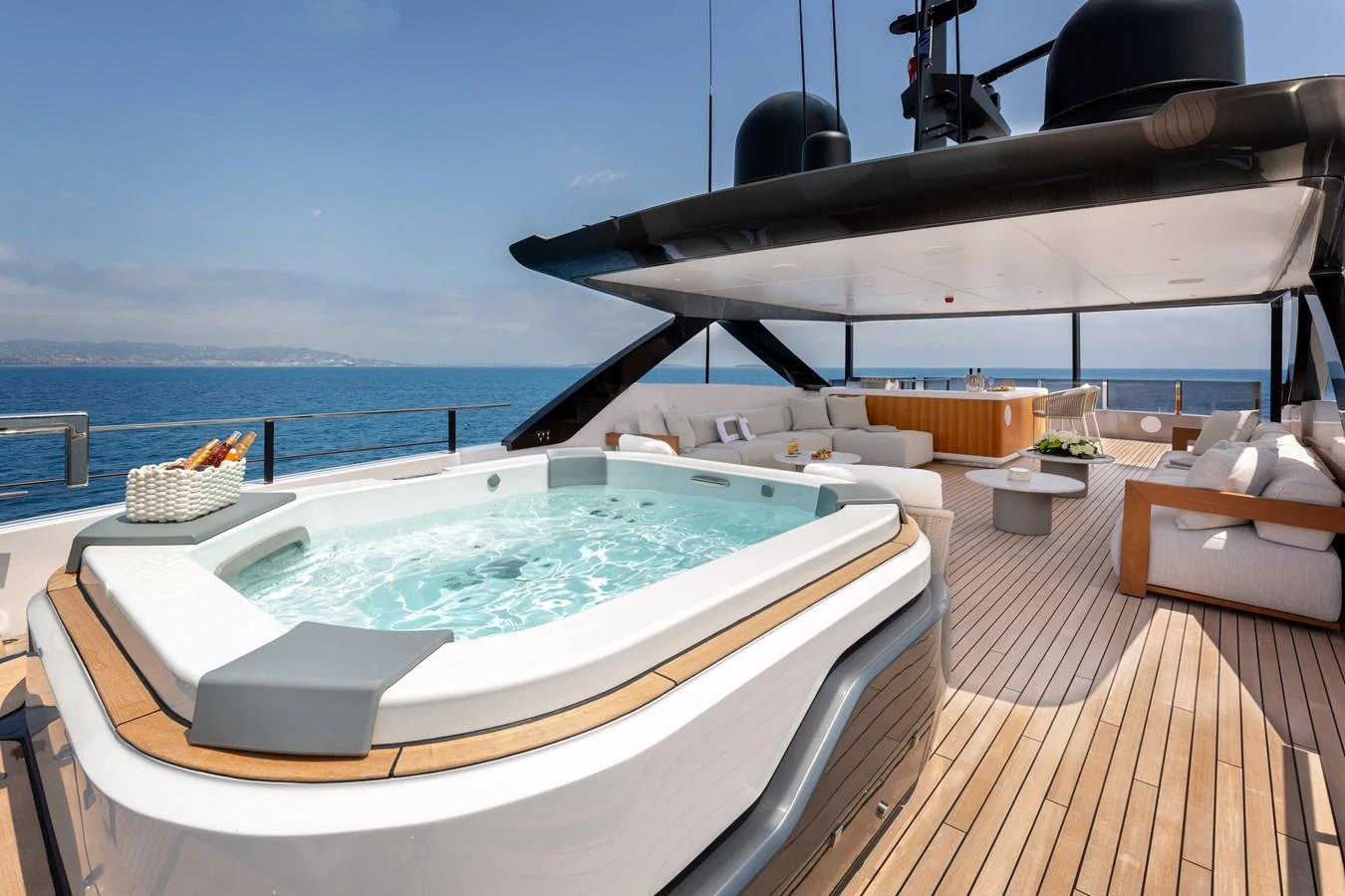 The sundeck features a luxurious jacuzzi with ample seating and stunning ocean views. aboard LADY DIA Yacht for Sale