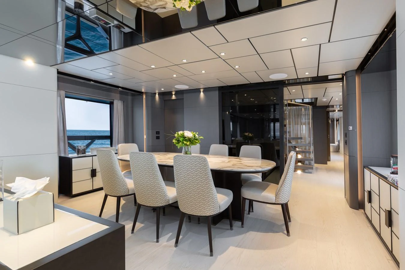 The yacht's dining area features a modern, elegant design with a large table and comfortable seating. aboard LADY DIA Yacht for Sale