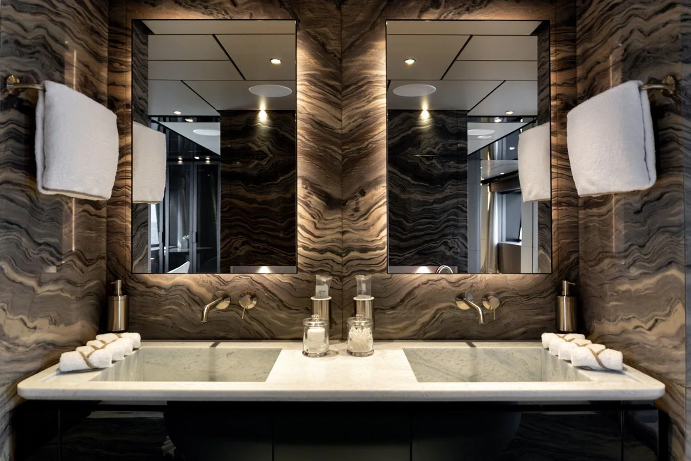 A luxurious yacht bathroom featuring a double vanity with elegant fixtures and marble accents. aboard LADY DIA Yacht for Sale