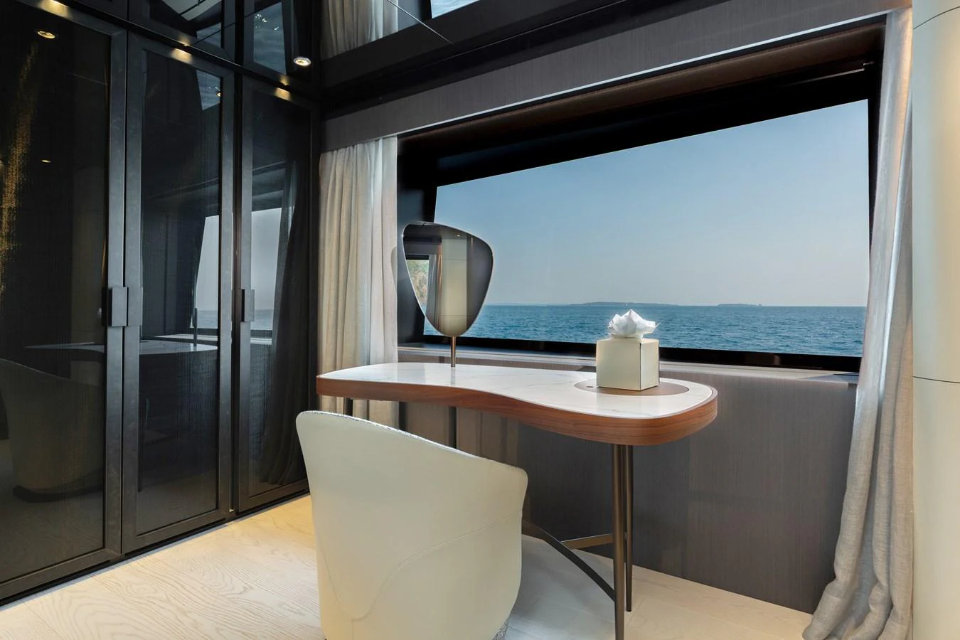 A serene office space with a large window offering a stunning ocean view. aboard LADY DIA Yacht for Sale