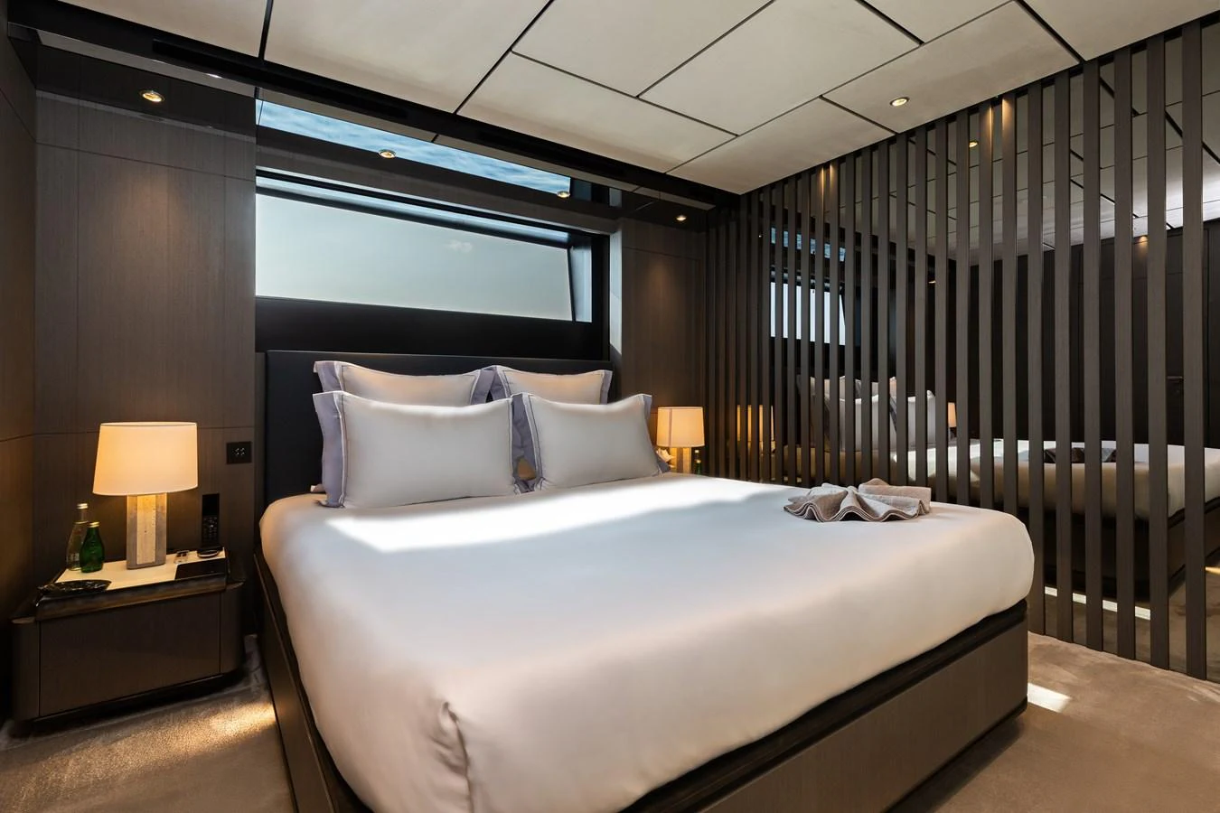 The stateroom features a luxurious bed with elegant lighting and modern design elements. aboard LADY DIA Yacht for Sale