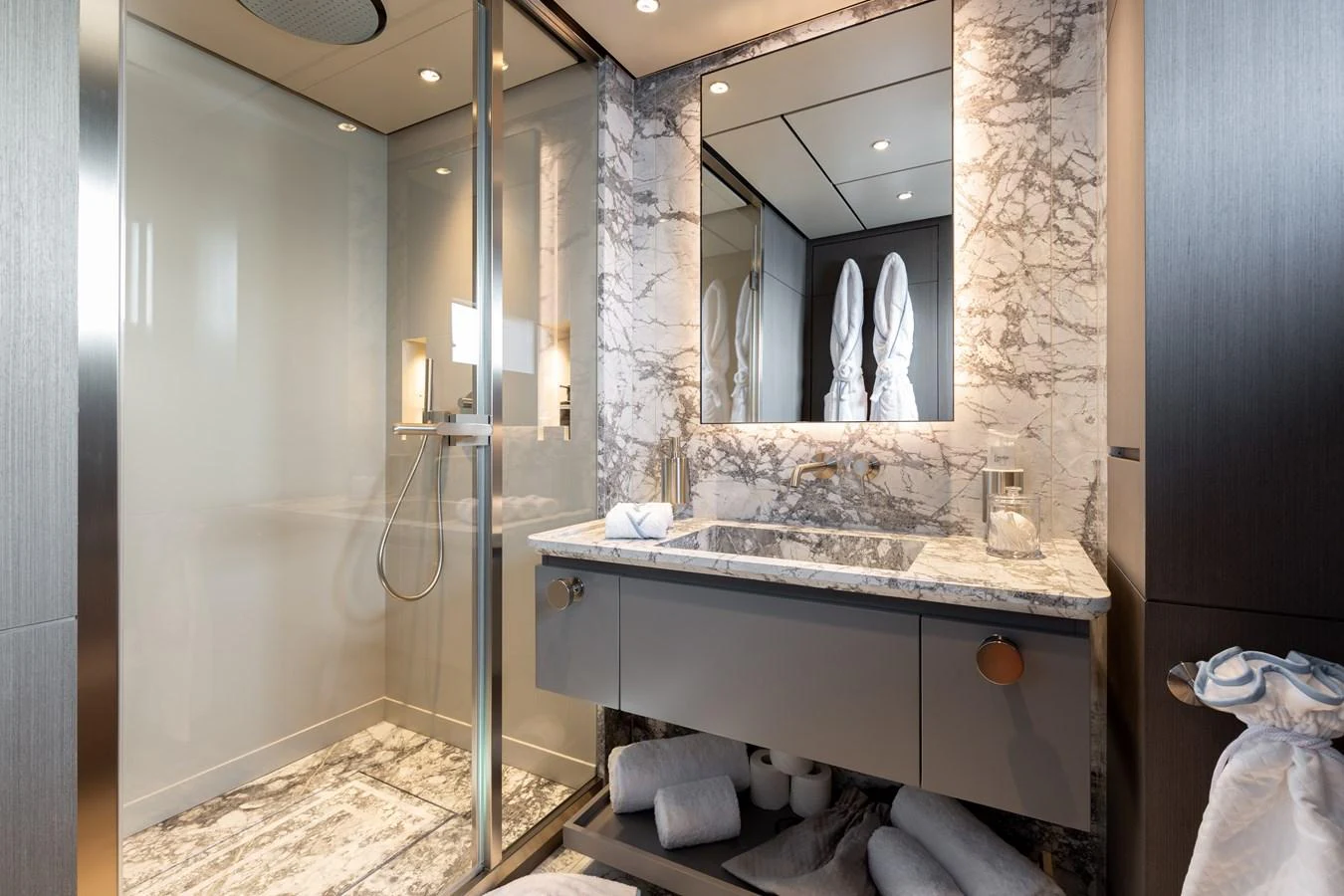 A luxurious yacht bathroom featuring a marble countertop and a spacious shower area. aboard LADY DIA Yacht for Sale