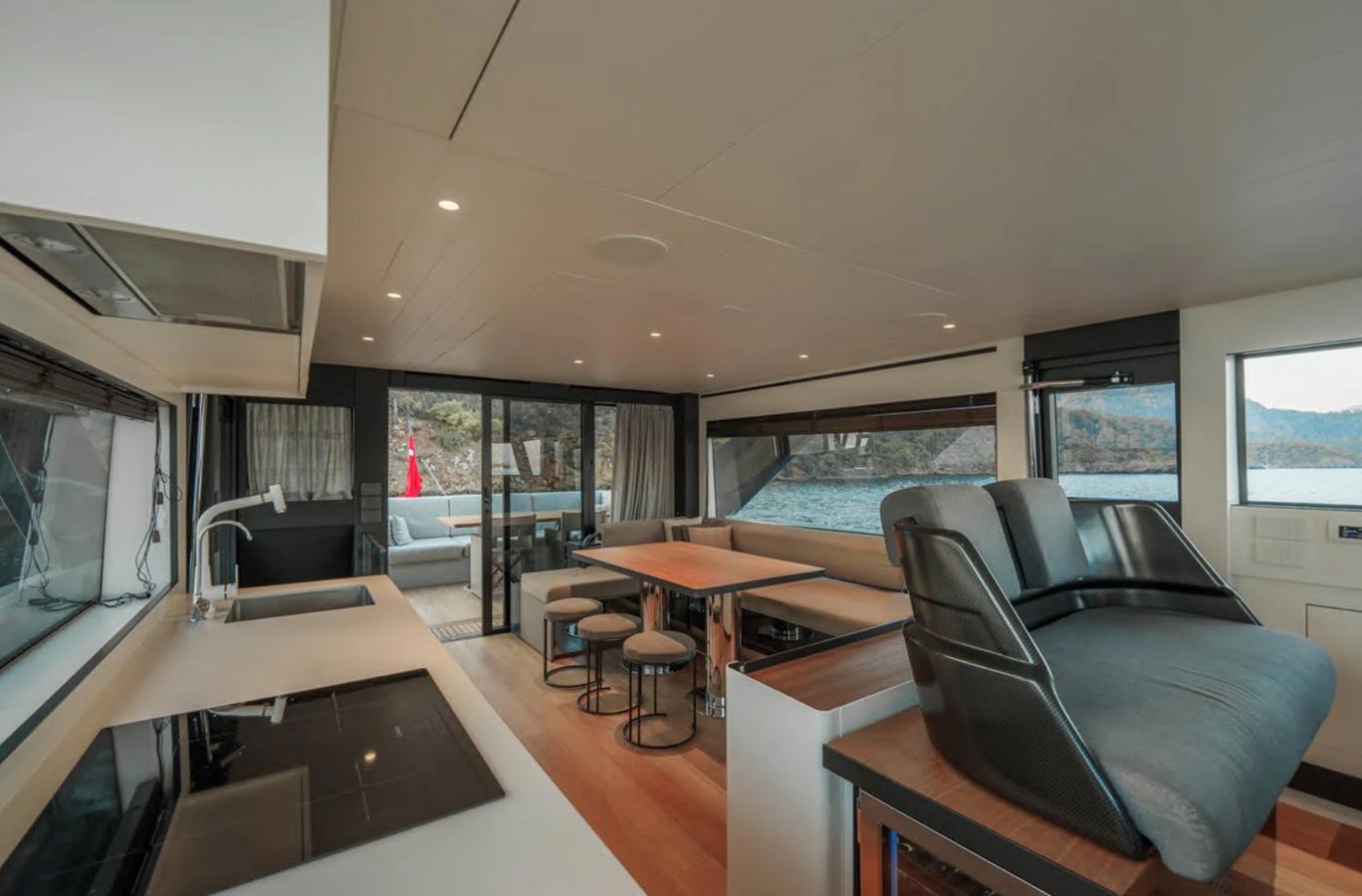 The salon offers a spacious and modern living area with large windows providing stunning views. aboard OUT OF THE BLUE Yacht for Sale