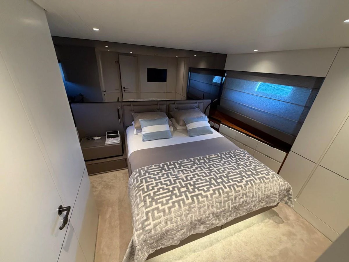 The master stateroom features a luxurious bed with elegant bedding and modern decor. aboard OUT OF THE BLUE Yacht for Sale