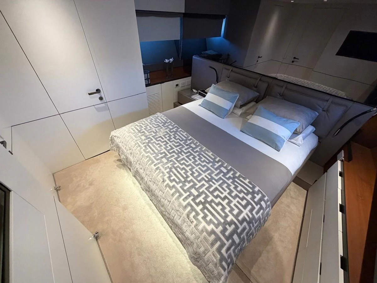 A luxurious stateroom featuring a comfortable bed with elegant bedding and modern decor. aboard OUT OF THE BLUE Yacht for Sale