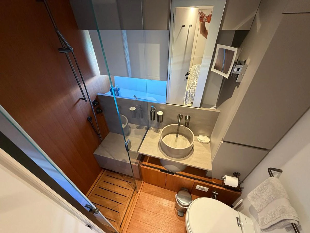 A modern yacht bathroom with sleek fixtures and a compact design. aboard OUT OF THE BLUE Yacht for Sale