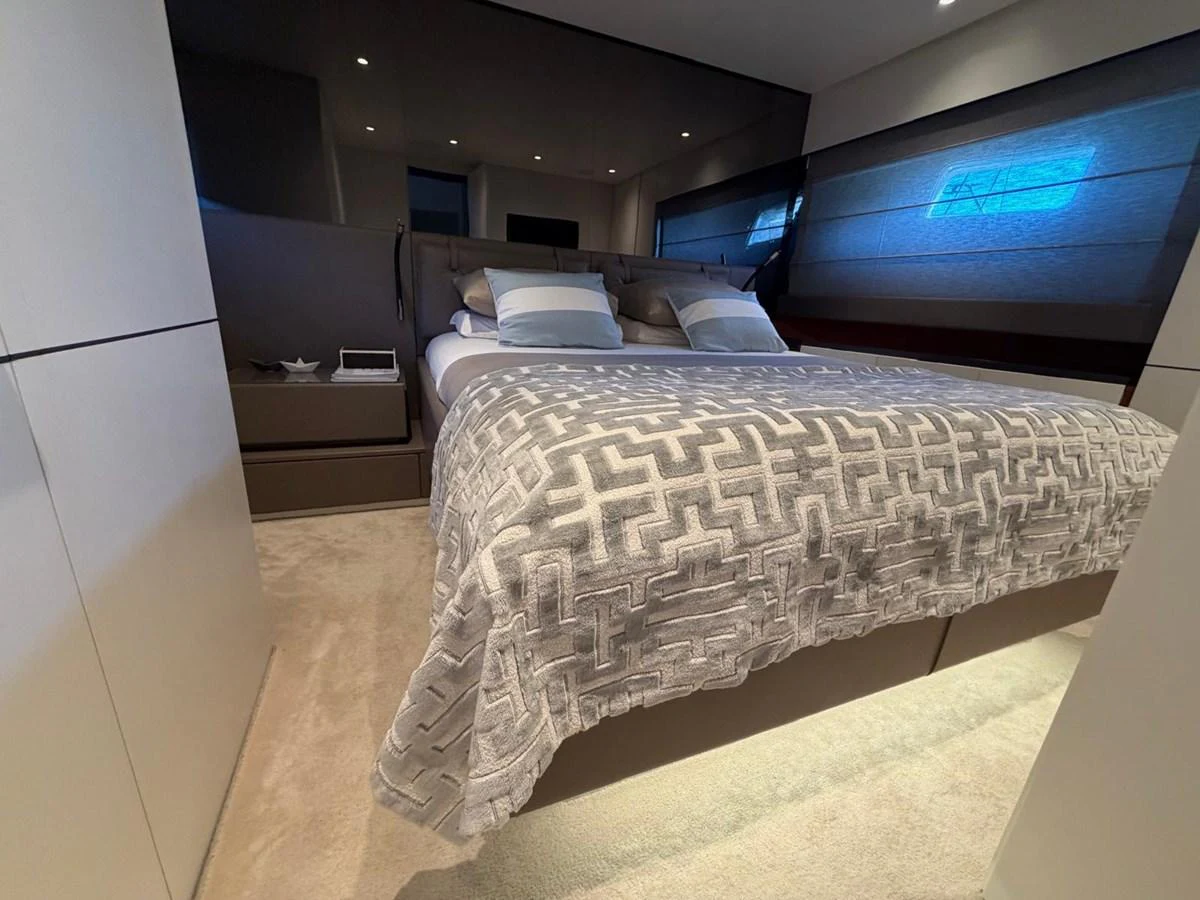 The stateroom features a plush bed with elegant bedding and ambient lighting for a cozy retreat. aboard OUT OF THE BLUE Yacht for Sale