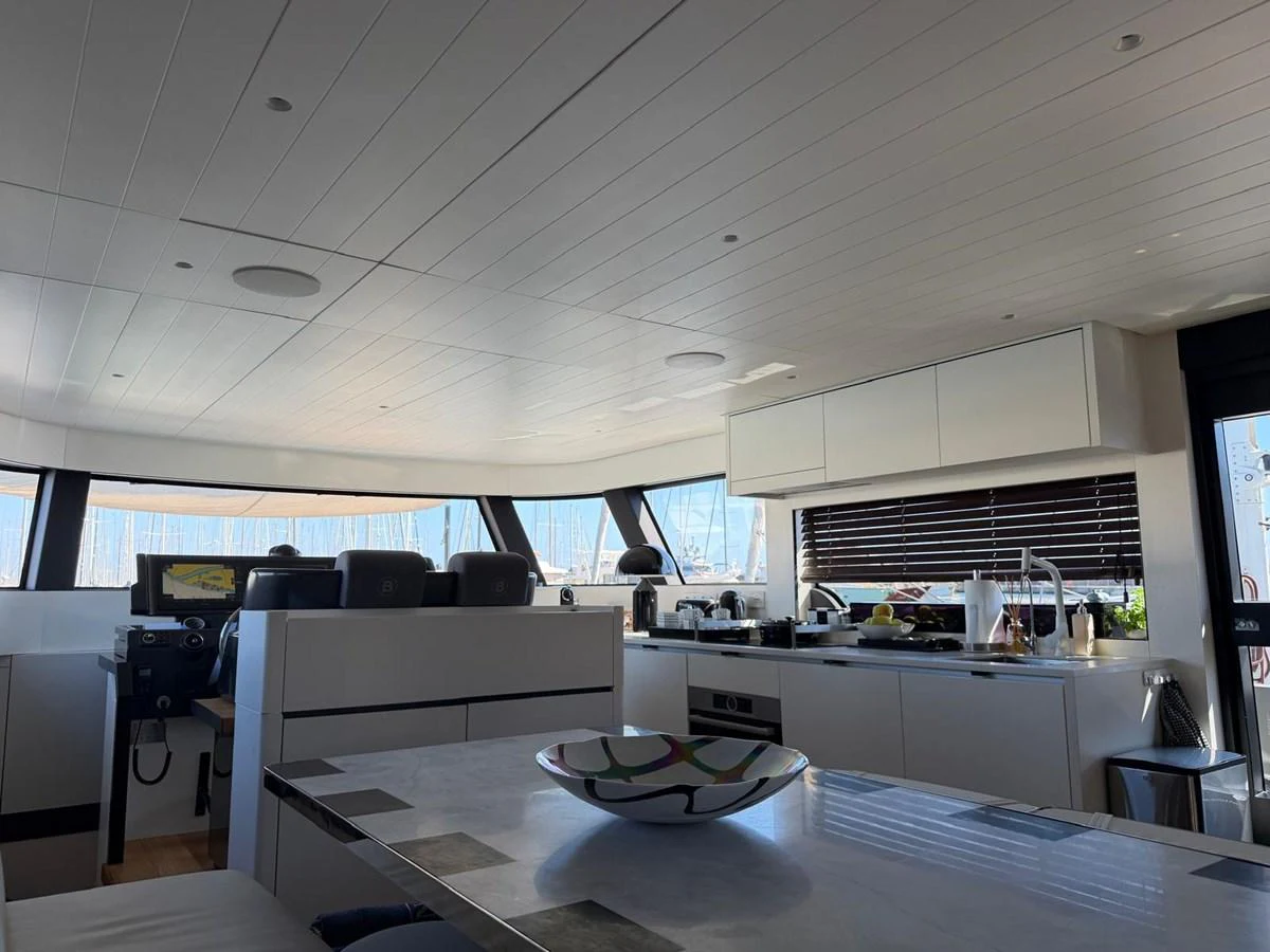 A modern galley with sleek cabinetry and a spacious dining area. aboard OUT OF THE BLUE Yacht for Sale