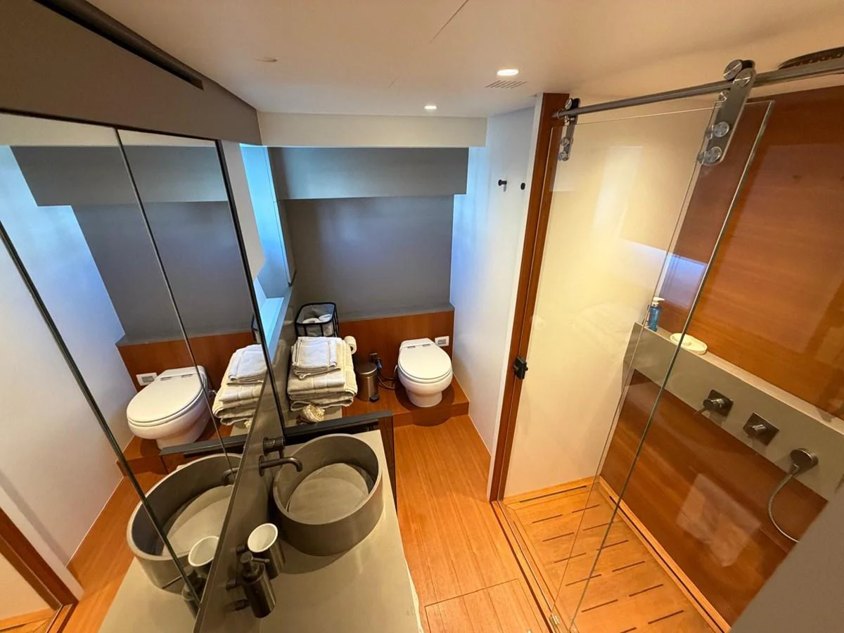 The yacht's bathroom features modern fixtures and a spacious shower area. aboard OUT OF THE BLUE Yacht for Sale