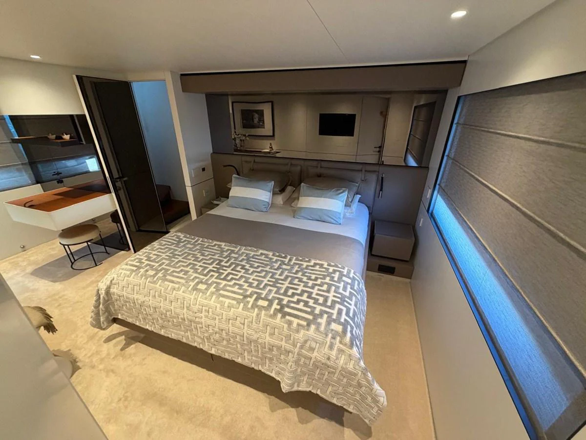 A cozy and well-appointed stateroom featuring a comfortable bed and modern decor. aboard OUT OF THE BLUE Yacht for Sale