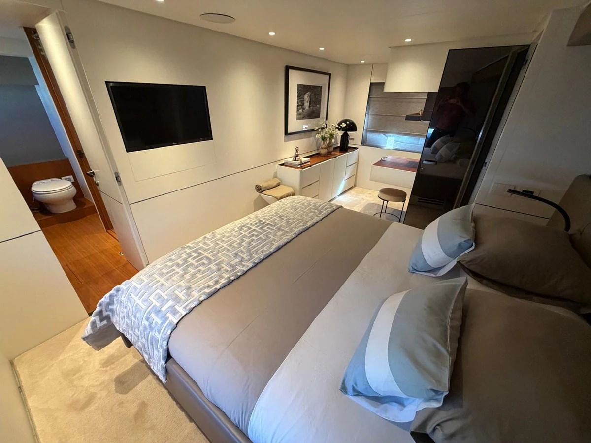 The stateroom features a comfortable bed, modern decor, and a sleek, functional design. aboard OUT OF THE BLUE Yacht for Sale