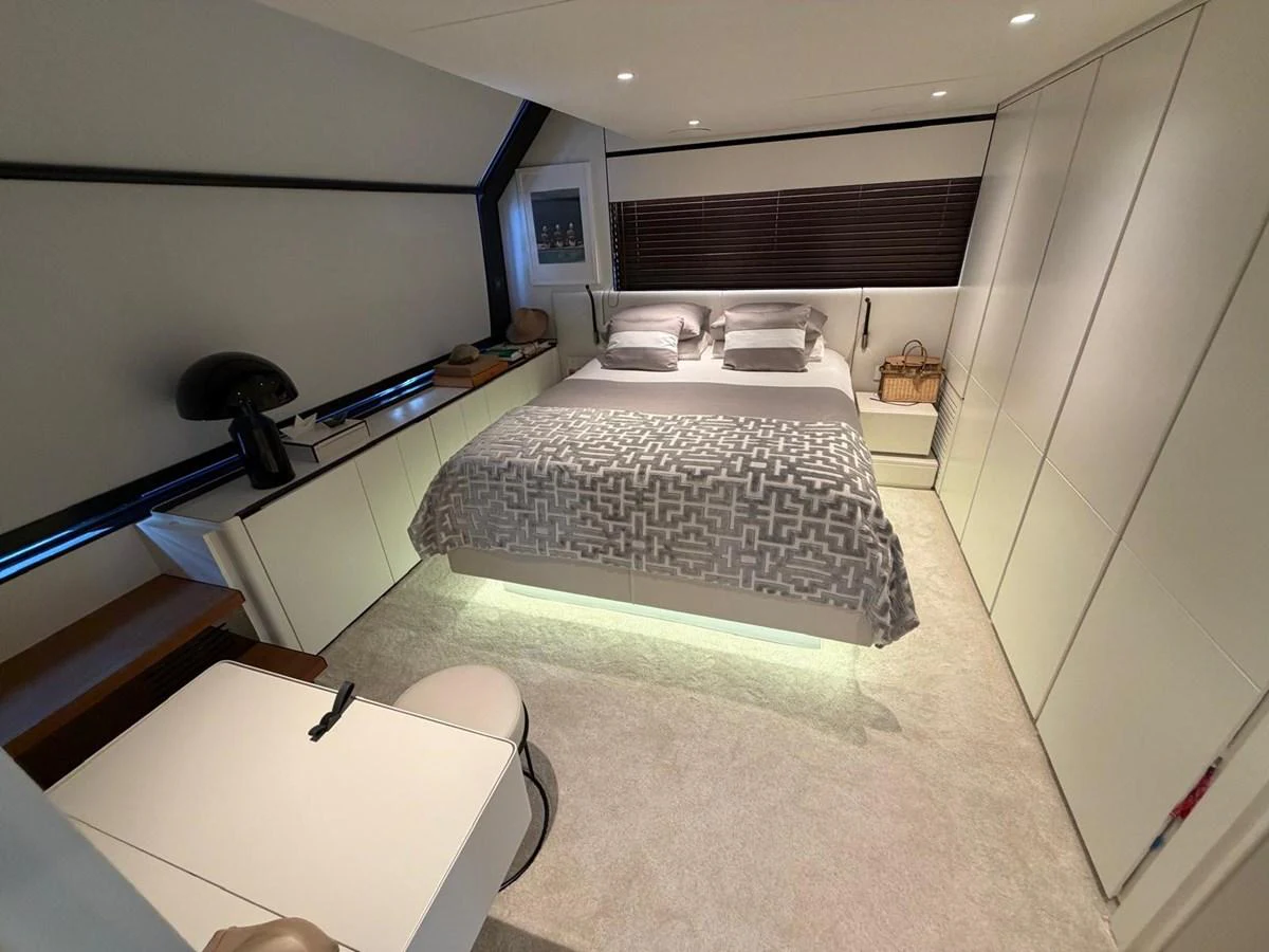 The stateroom features a modern design with a comfortable bed and ample storage space. aboard OUT OF THE BLUE Yacht for Sale