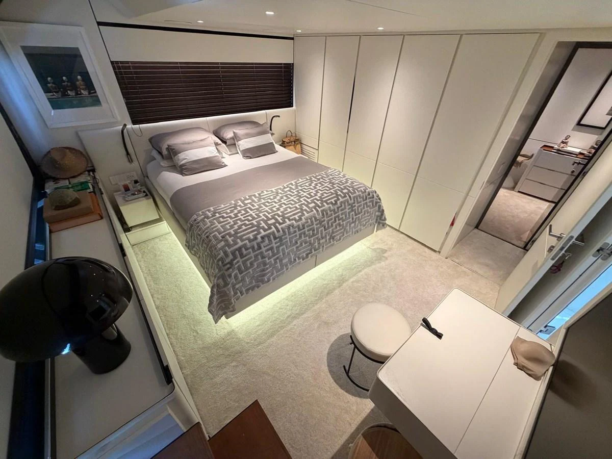 A luxurious stateroom featuring a comfortable bed with elegant bedding and ample storage space. aboard OUT OF THE BLUE Yacht for Sale