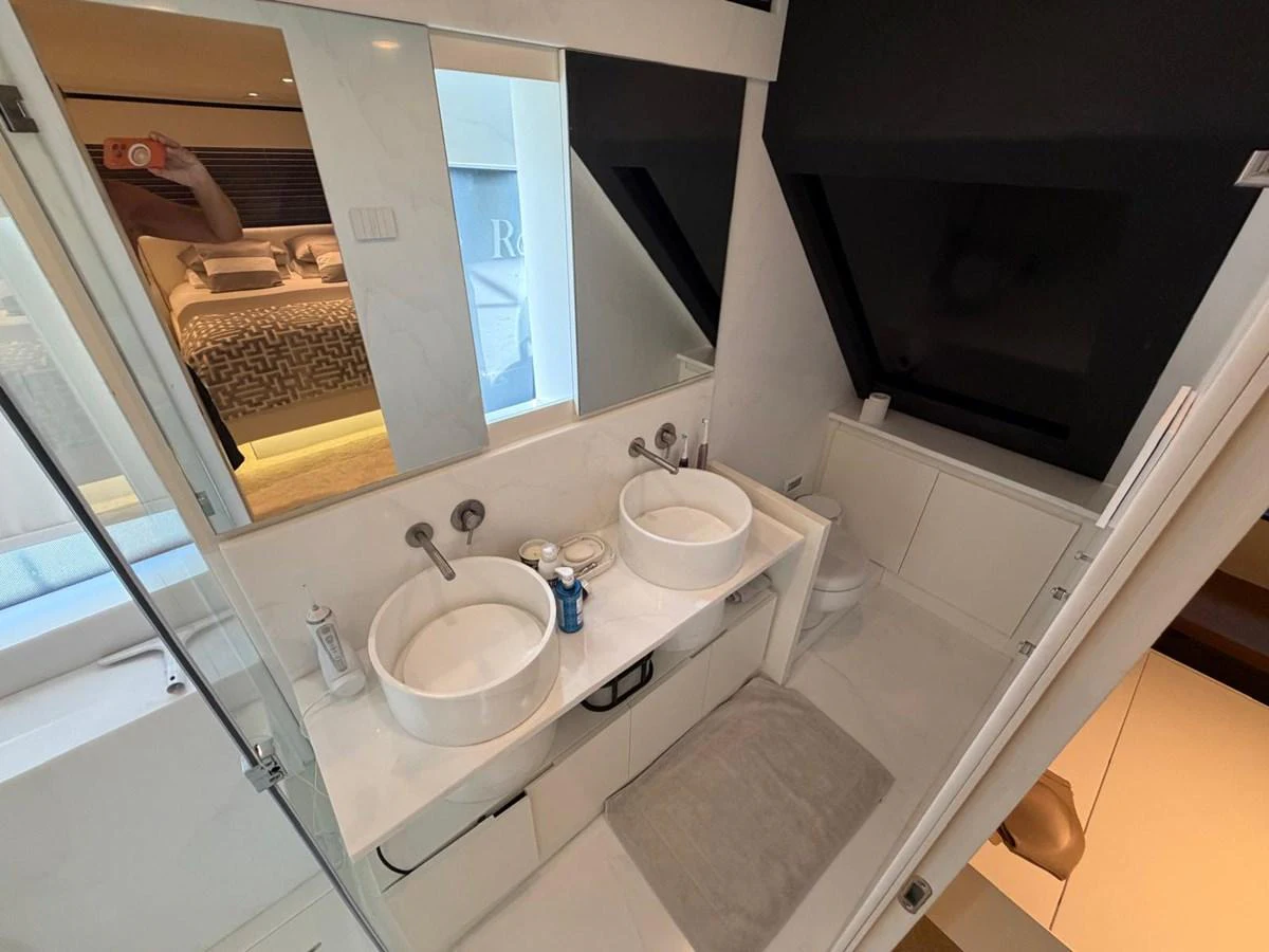The yacht's bathroom features dual sinks and a modern, sleek design. aboard OUT OF THE BLUE Yacht for Sale