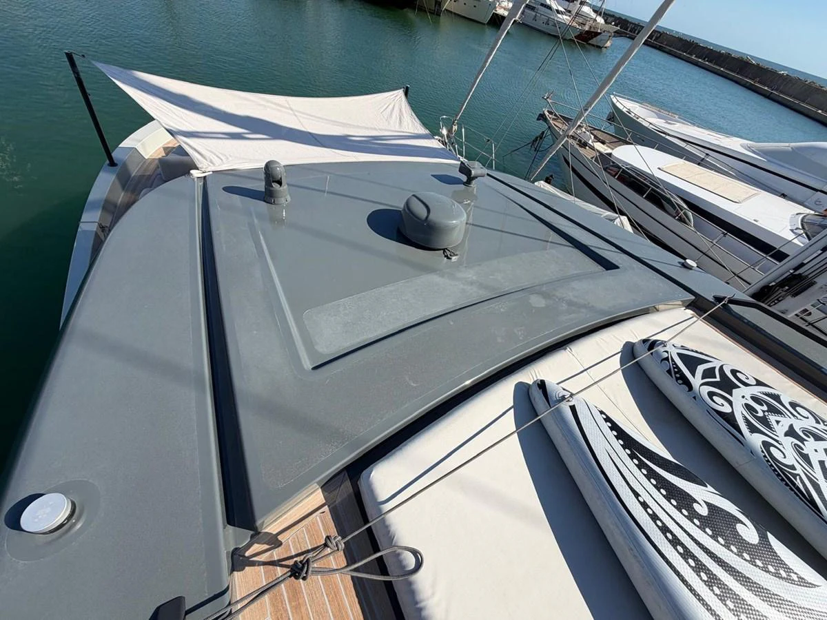 A close-up view of the yacht's deck with paddleboards and a shaded area. aboard OUT OF THE BLUE Yacht for Sale