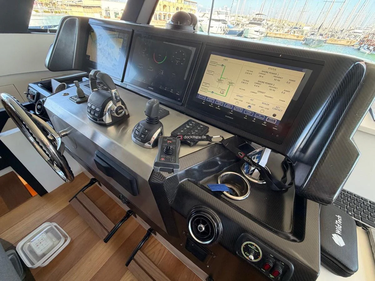 The helm station features advanced navigation and control systems with a sleek, modern design. aboard OUT OF THE BLUE Yacht for Sale