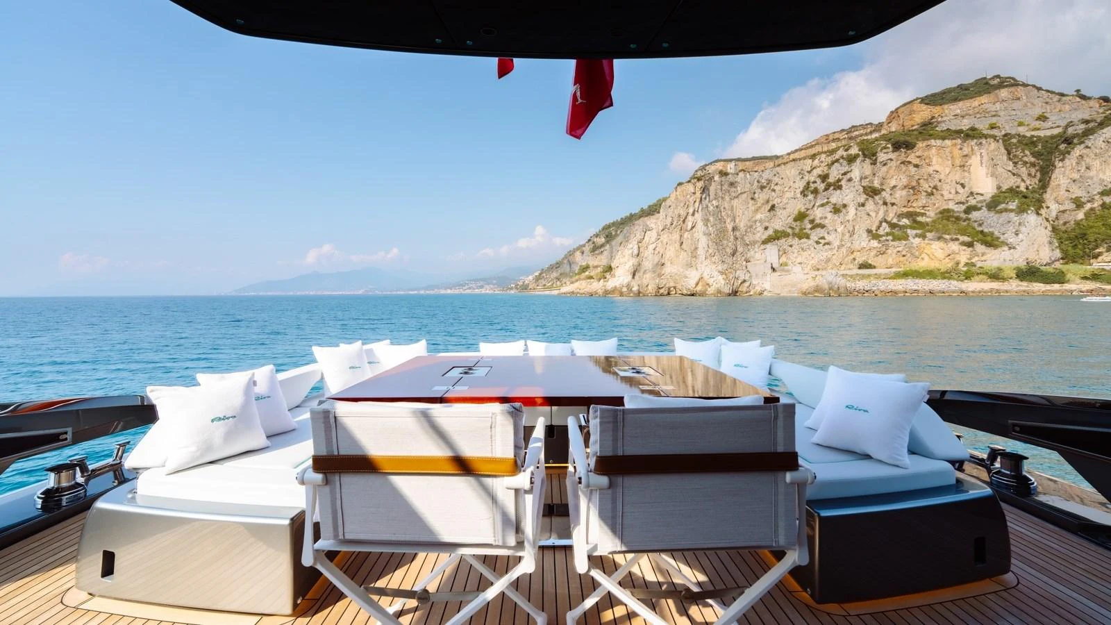 The aft deck features a spacious and inviting seating area with a stunning view of the coastline. aboard MAYAR Yacht for Sale