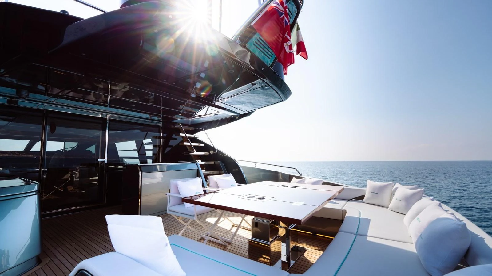 The aft deck offers a luxurious outdoor seating area with a dining table, perfect for enjoying meals with a view of the sea. aboard MAYAR Yacht for Sale