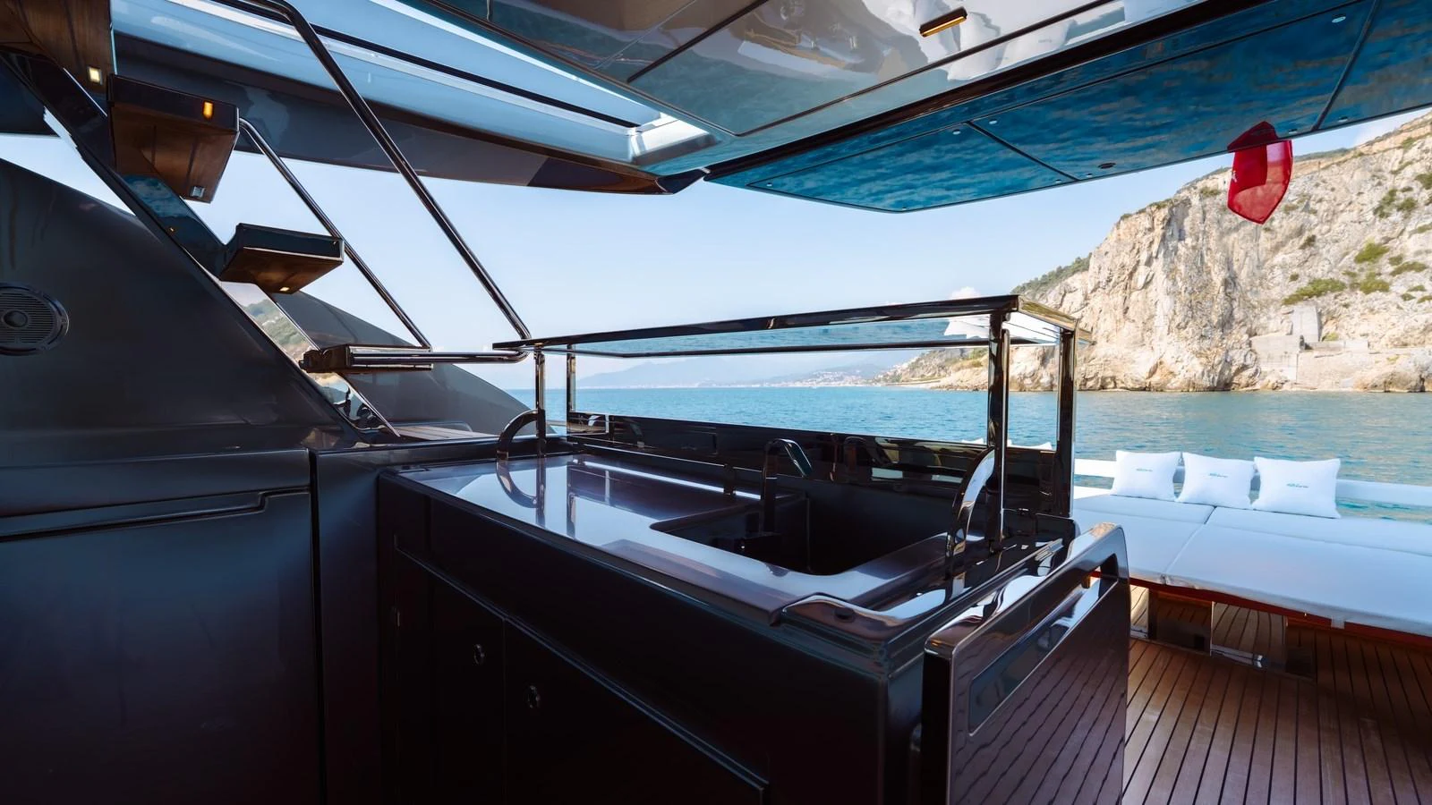 The yacht's aft deck offers a sleek and modern outdoor space with stunning views of the surrounding waters and cliffs. aboard MAYAR Yacht for Sale