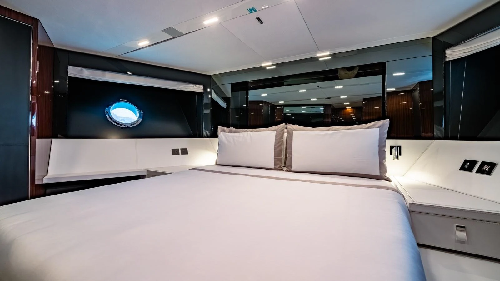 The stateroom features a plush bed with modern lighting and a sleek design. aboard MAYAR Yacht for Sale