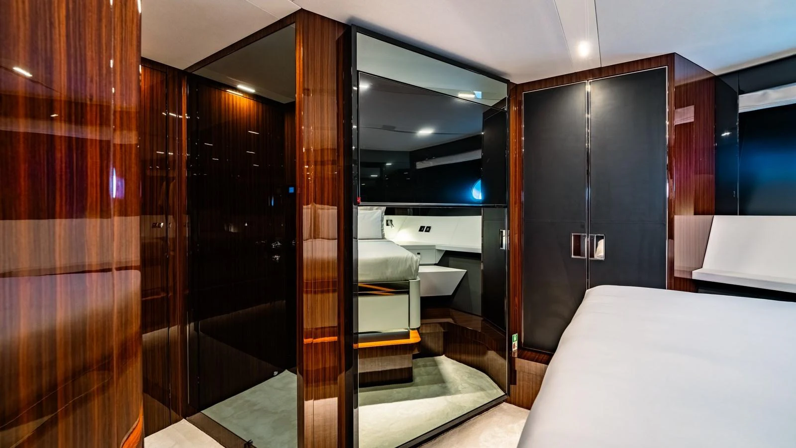 The yacht's interior showcases a sleek, modern design with high-gloss wood finishes and luxurious furnishings. aboard MAYAR Yacht for Sale