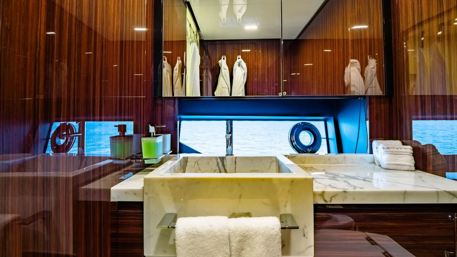 The yacht's bathroom features luxurious marble countertops and rich wooden cabinetry. aboard MAYAR Yacht for Sale