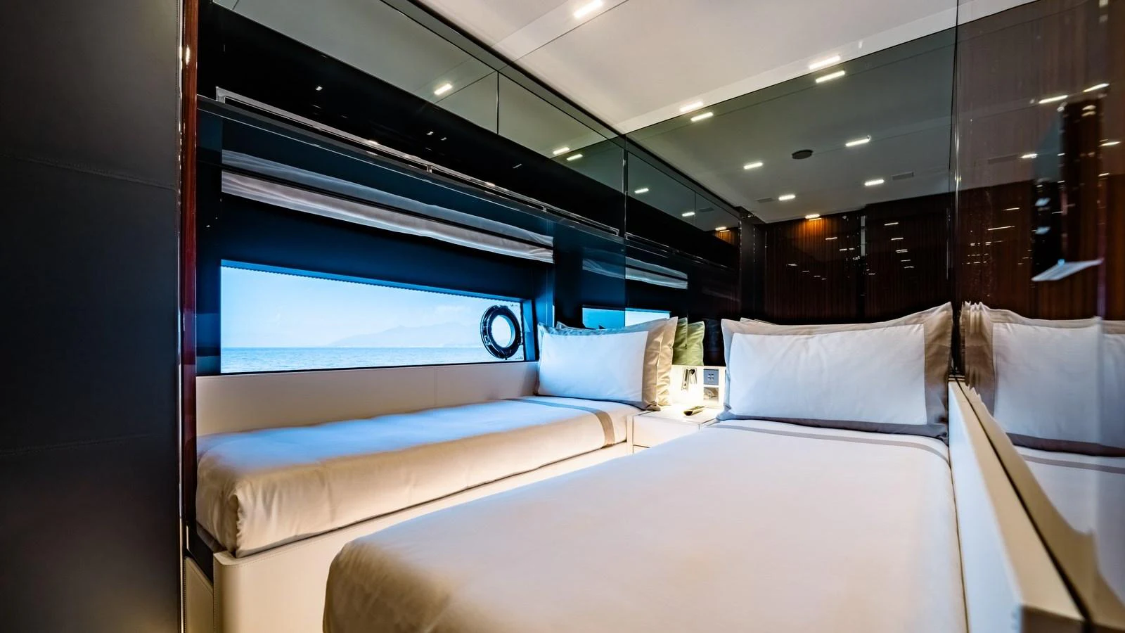 The stateroom features a sleek, modern design with a large window offering stunning ocean views. aboard MAYAR Yacht for Sale