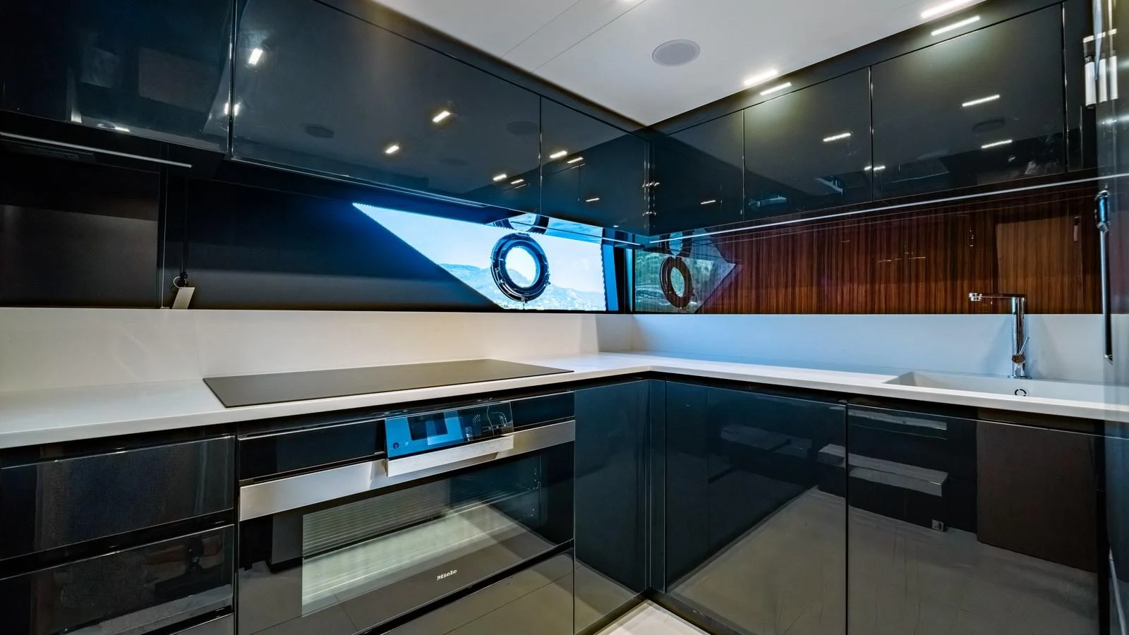 The sleek and modern galley features high-gloss cabinetry and state-of-the-art appliances. aboard MAYAR Yacht for Sale