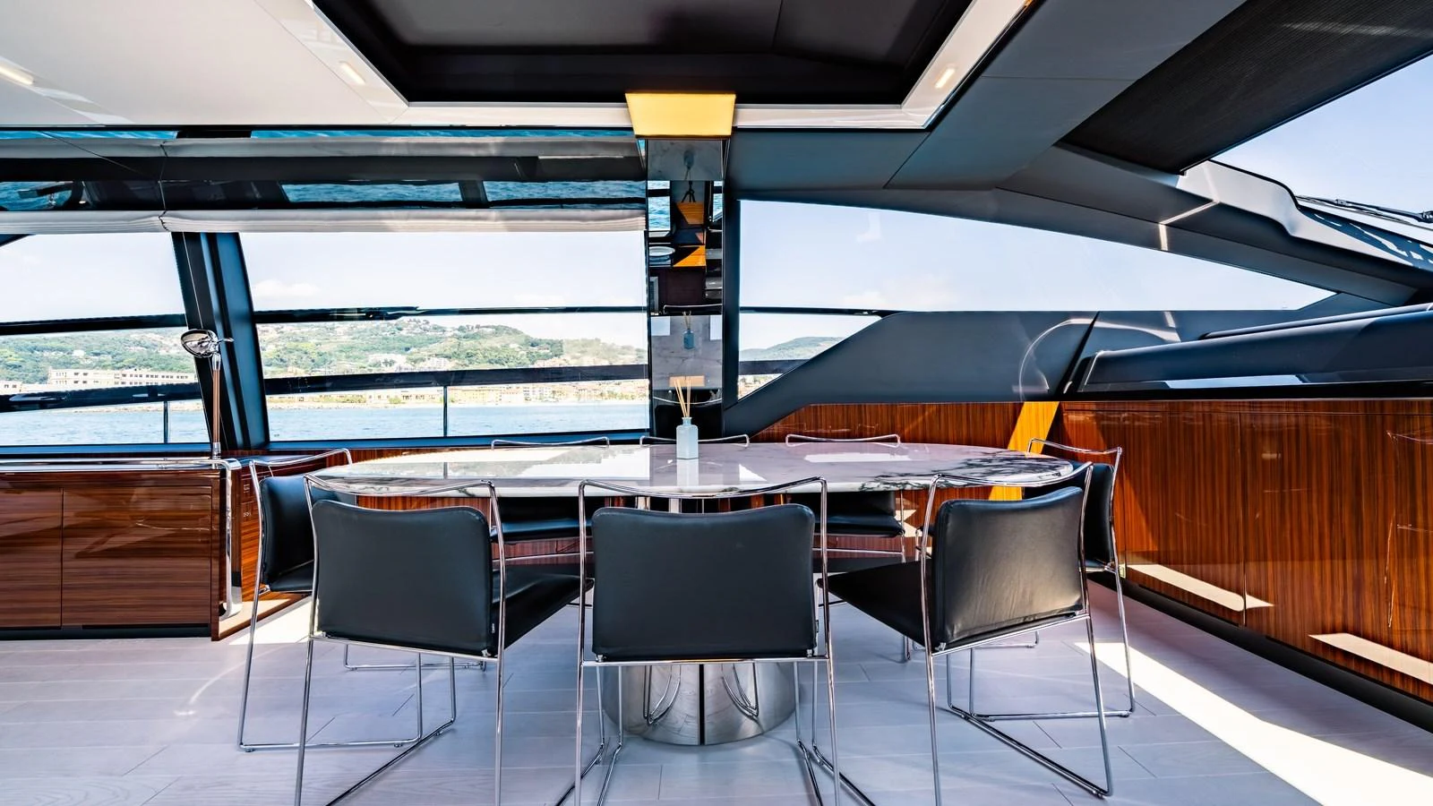 The yacht's dining area features a sleek, modern design with panoramic windows offering stunning views. aboard MAYAR Yacht for Sale