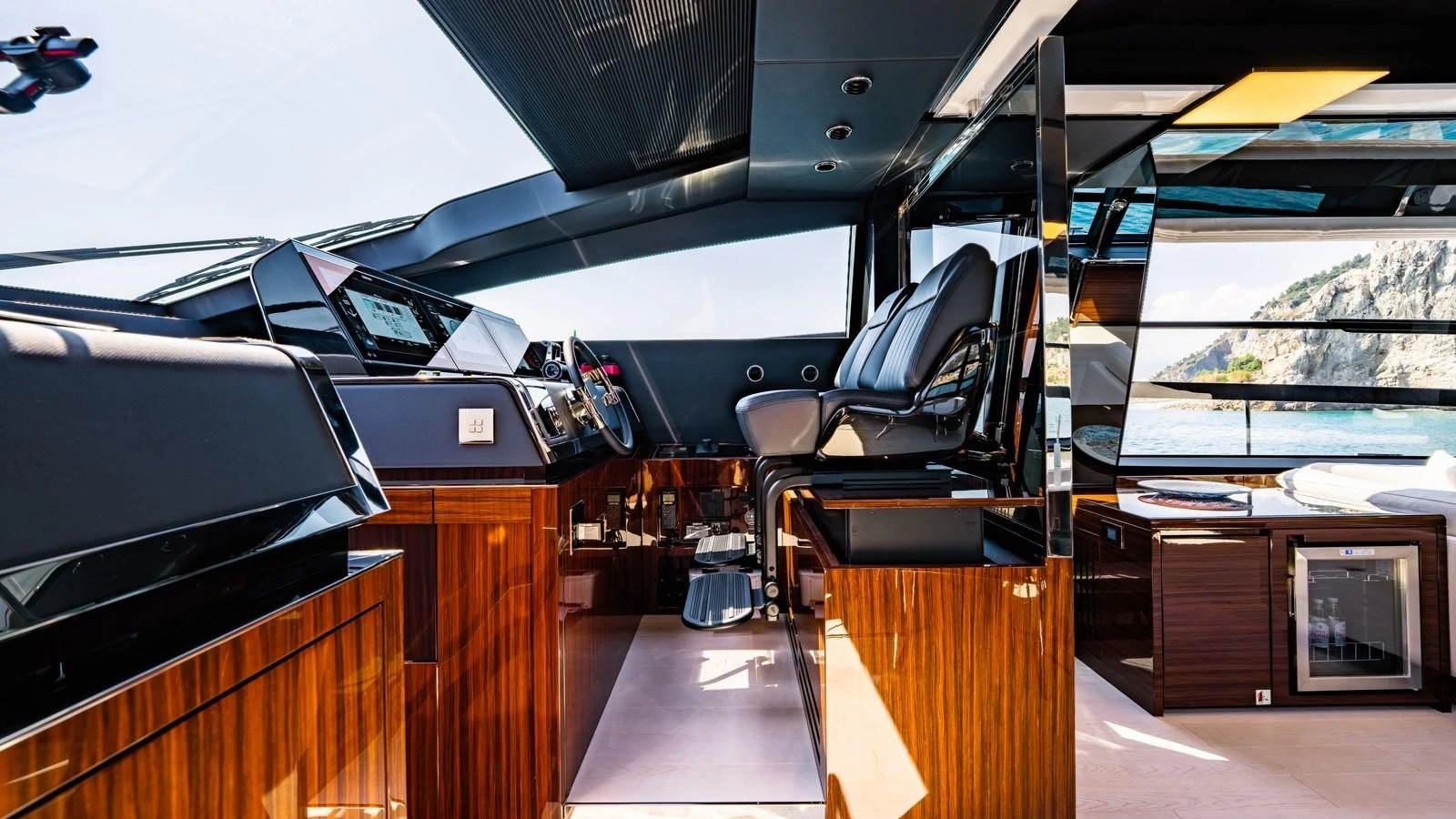 The helm of this yacht features sleek, modern design with luxurious wood finishes and state-of-the-art navigation equipment. aboard MAYAR Yacht for Sale