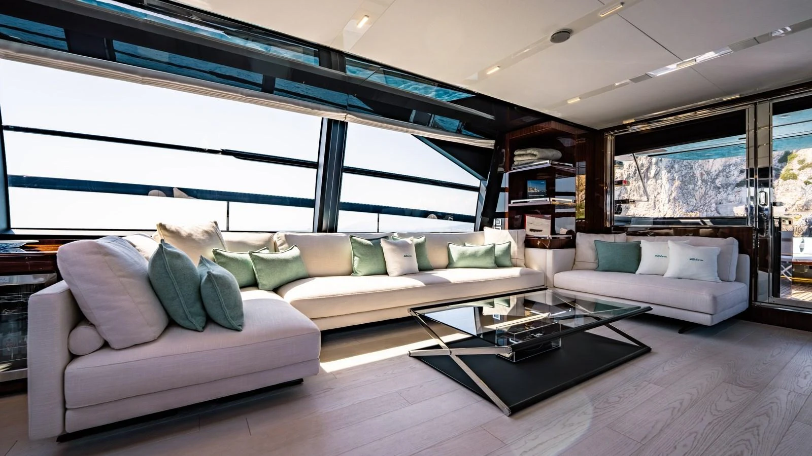 The salon features plush seating with panoramic windows offering stunning views. aboard MAYAR Yacht for Sale
