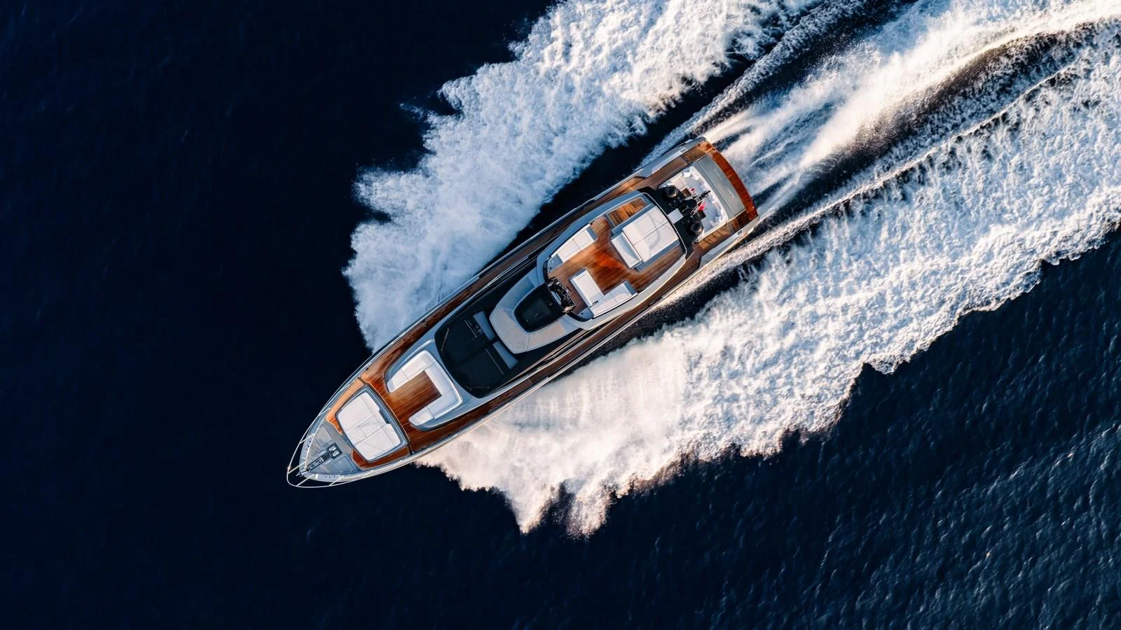 A sleek yacht cruises swiftly through the water, leaving a trail of white foam in its wake. aboard MAYAR Yacht for Sale