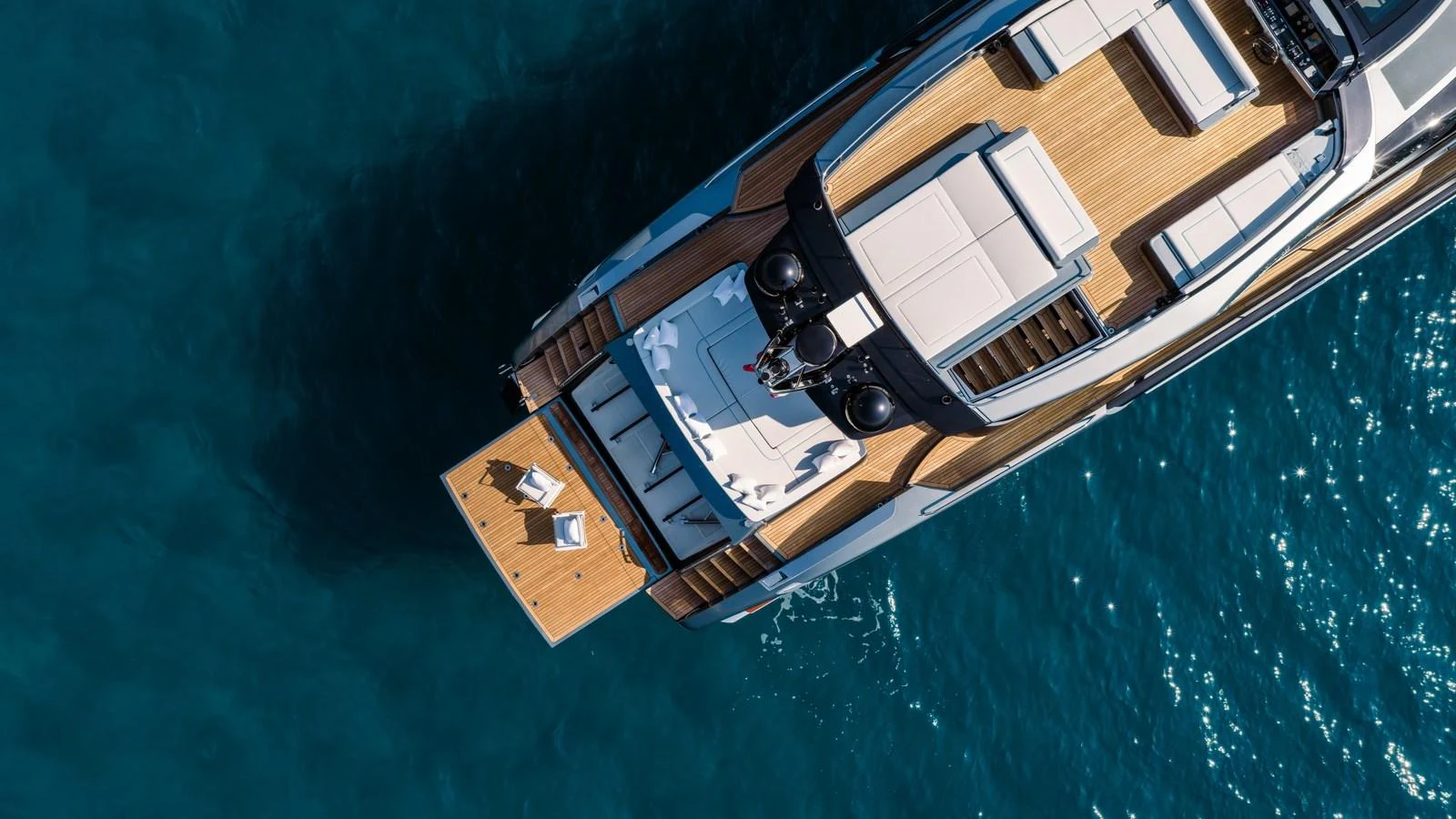 Aerial view of a luxurious yacht's deck featuring sun loungers and a swim platform. aboard MAYAR Yacht for Sale