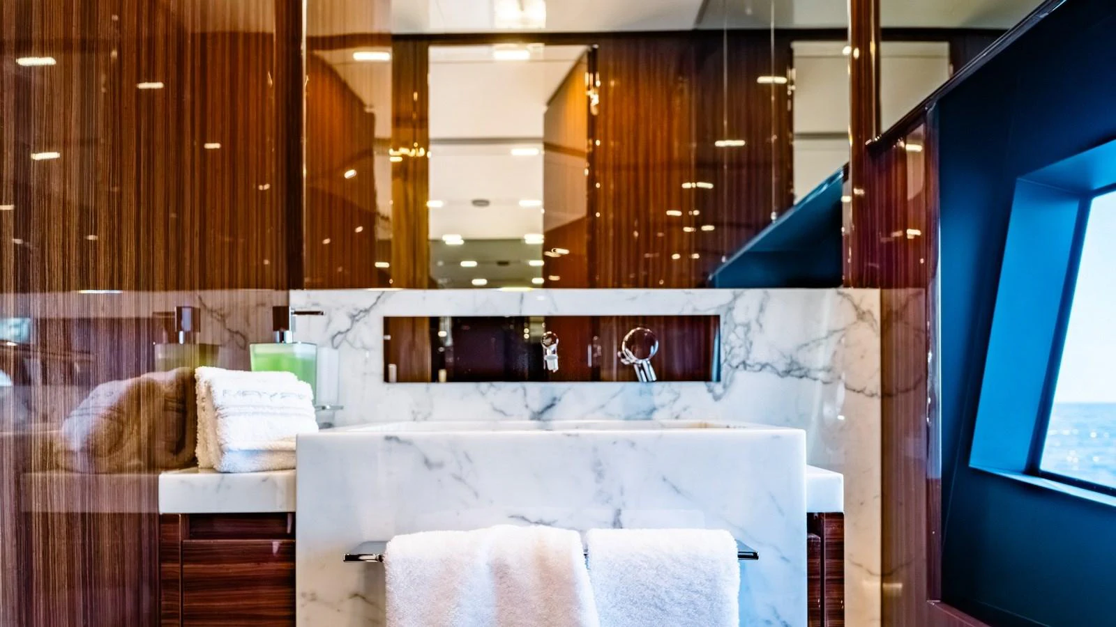 The yacht's bathroom features luxurious marble finishes and sleek wooden cabinetry. aboard MAYAR Yacht for Sale