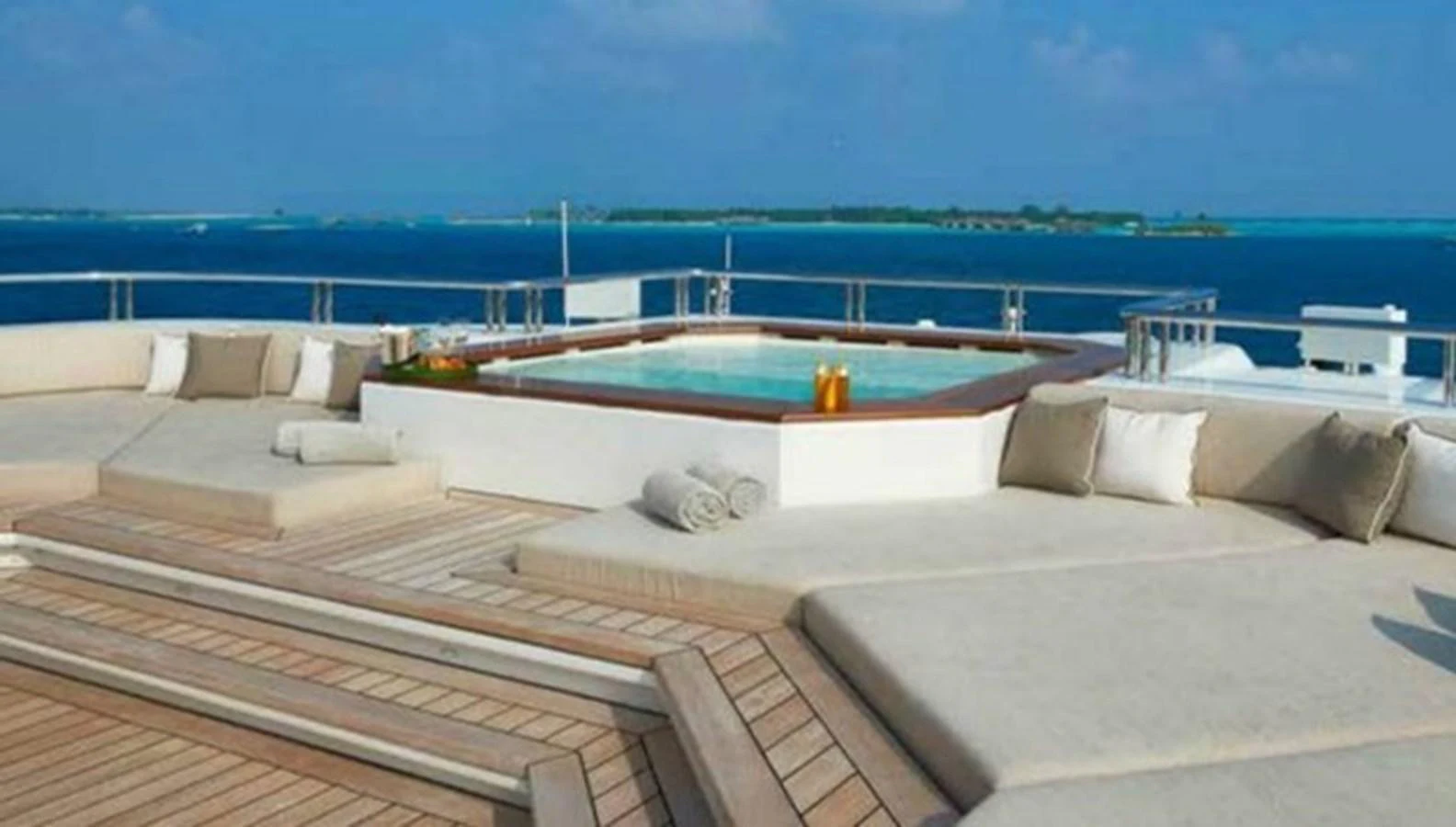 The sundeck features luxurious lounging areas and a jacuzzi with stunning ocean views. aboard DYTAN Yacht for Sale