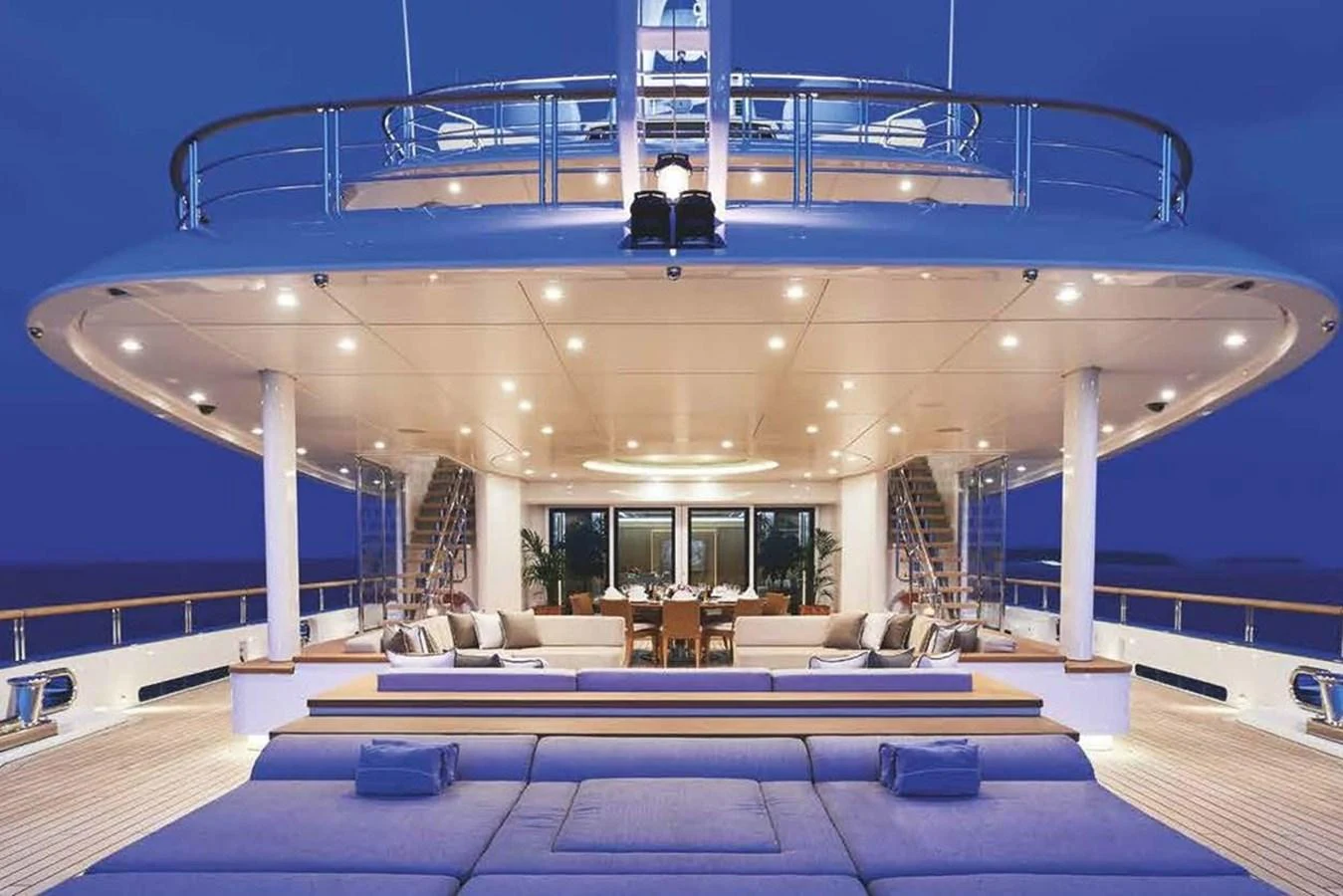 The yacht's aft deck offers a luxurious outdoor seating and dining area, perfect for evening relaxation. aboard DYTAN Yacht for Sale