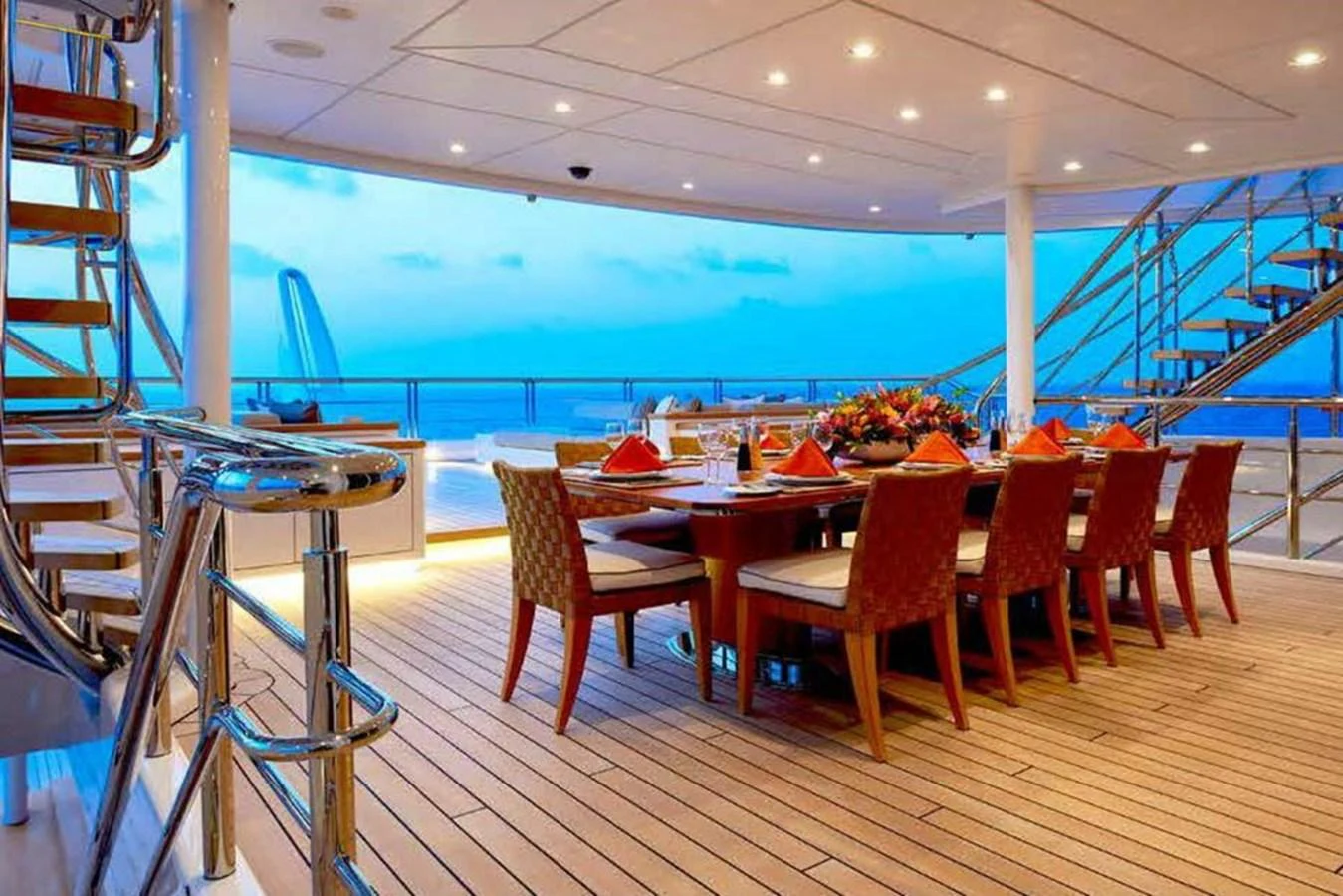 The yacht features an elegant outdoor dining area with a stunning ocean view. aboard DYTAN Yacht for Sale