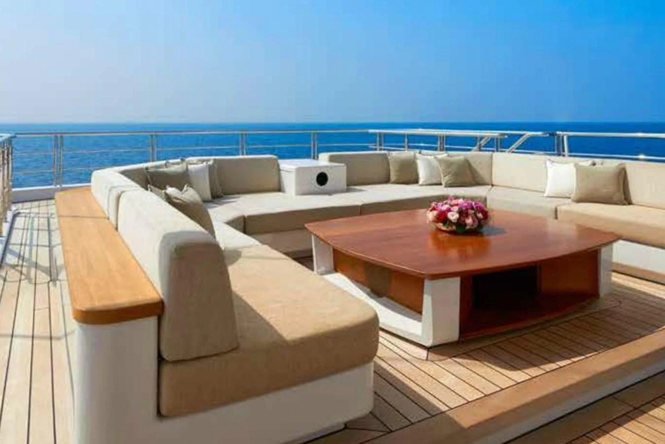 The sundeck features a spacious and comfortable seating area with a central coffee table, perfect for relaxation and socializing. aboard DYTAN Yacht for Sale